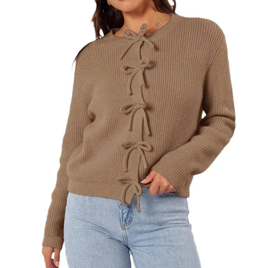 Women's long sleeve knitted cardigan with bow pattern in loose fit, available in multiple colours, shown on model