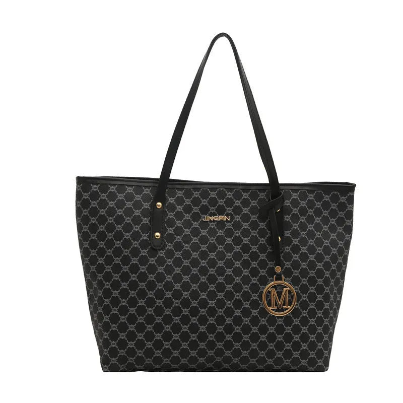 PU leather shoulder bag with adjustable strap in black, shown with visible stitching detail.