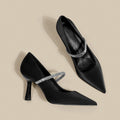 Women's black stiletto heel sandals with a closed toe and a silver buckle strap across the instep.