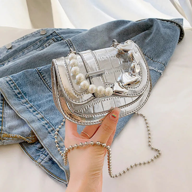 Silver women's PU leather mini saddle crossbody bag with square shape and single shoulder strap.