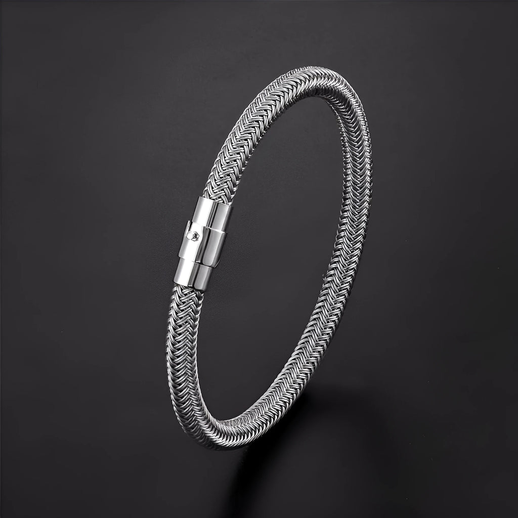 Geometric titanium steel wire bracelet with magnetic clasp on a wrist, showing minimalist unisex design.