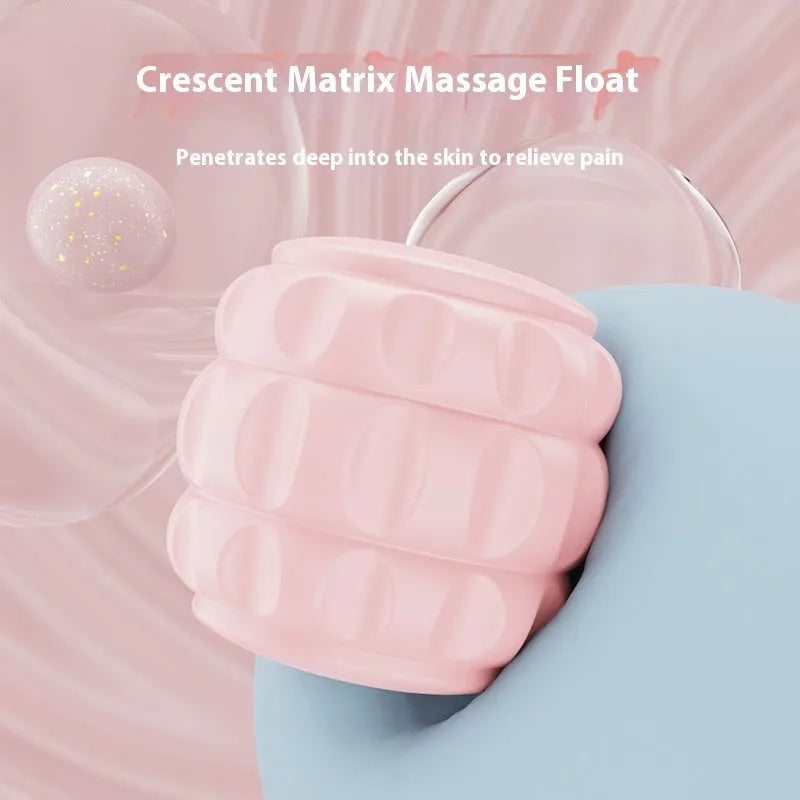 A small, handheld leg massage roller with double-row wheels in coral pink, shown on a table.