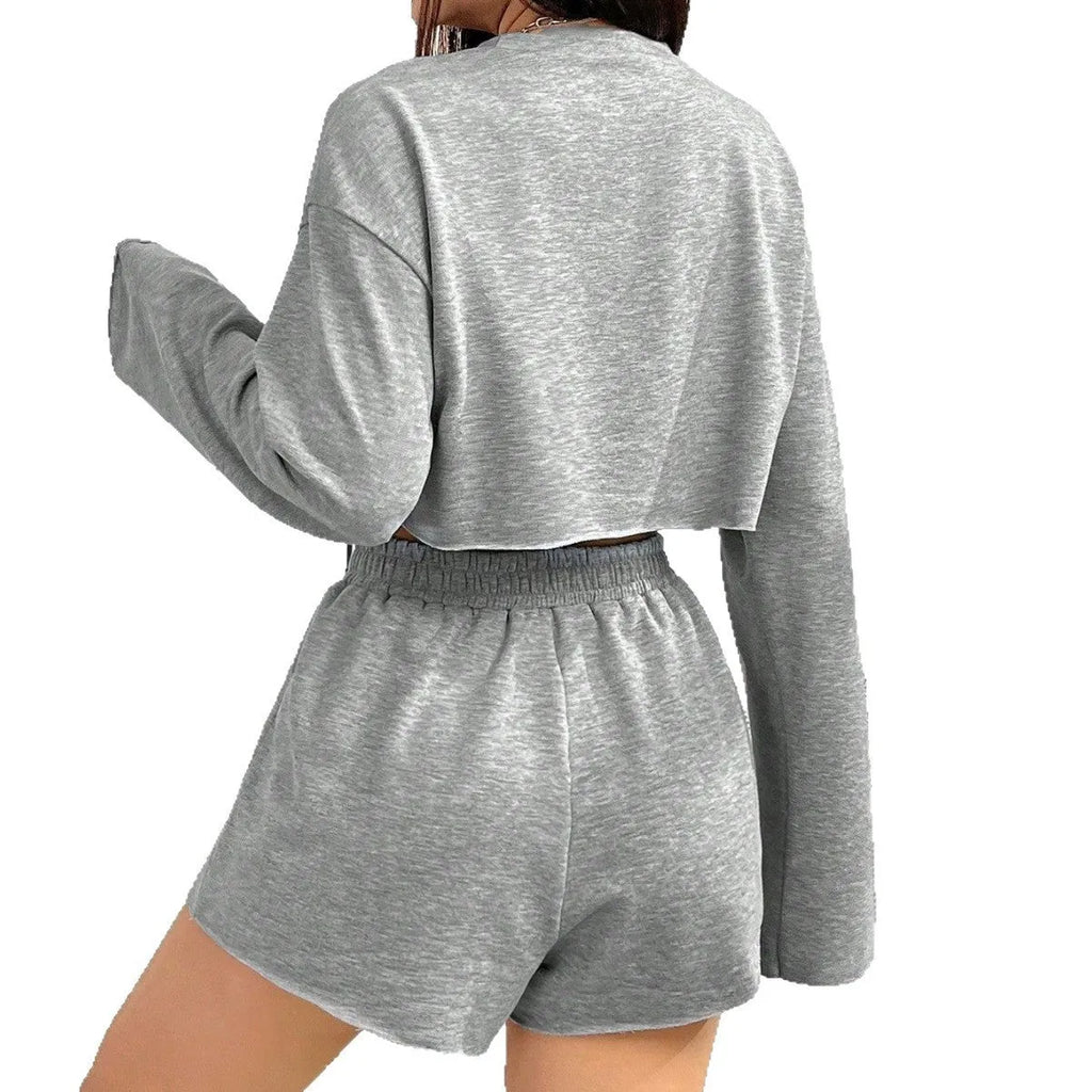 Grey women's long-sleeved t-shirt and matching shorts co-ord set laid flat.