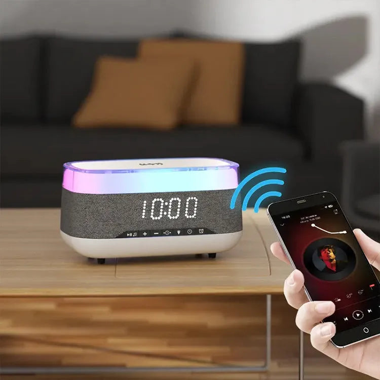 White multifunctional alarm clock with Bluetooth speaker and wireless charging pad on wooden table
