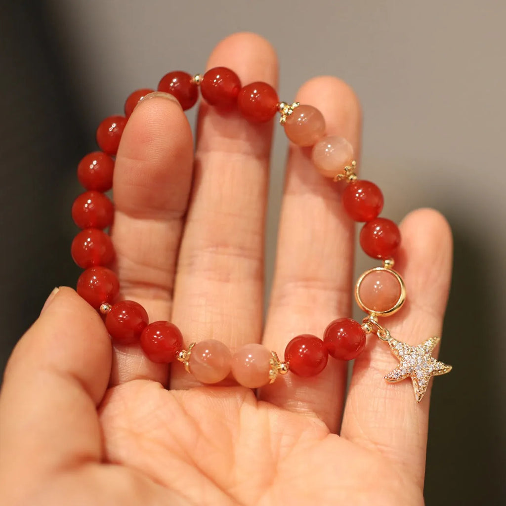 Handmade women's bracelet with 8mm red agate and orange sunstone beads, featuring star and cloud designs.