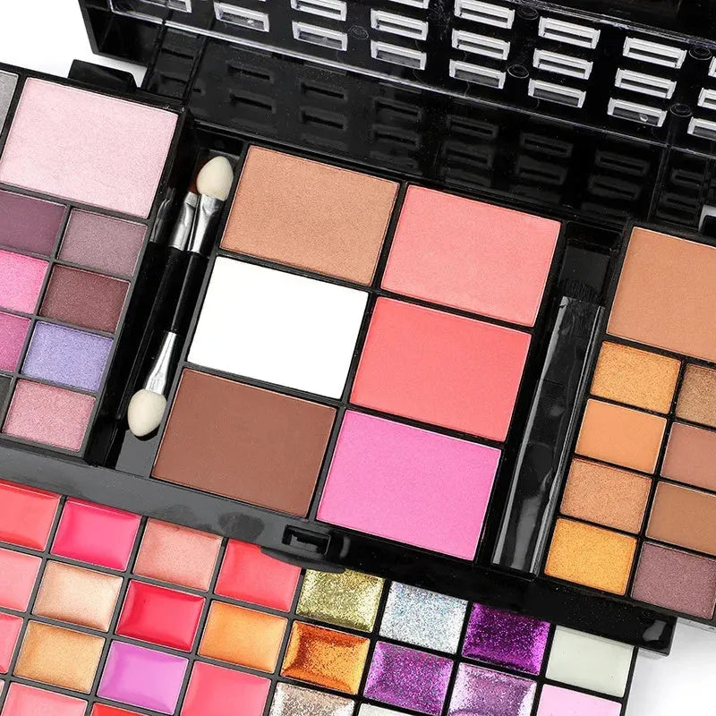 74 colour makeup palette set open to show eyeshadows, lip glosses and brushes in a plastic case with mirror