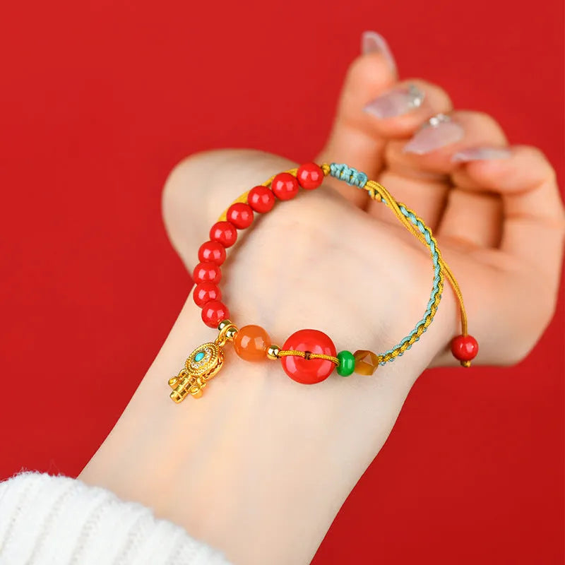 Red cinnabar bracelet with geometric patterns and peace buckle closure
