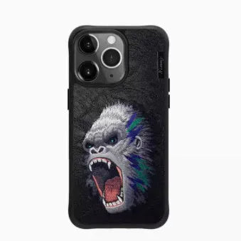 Red embroidered lion design TPU mobile phone case for iPhone 15 Pro Max on a surface