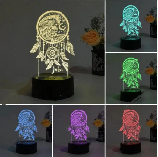 Modern acrylic dream catcher night light with remote control on a table.