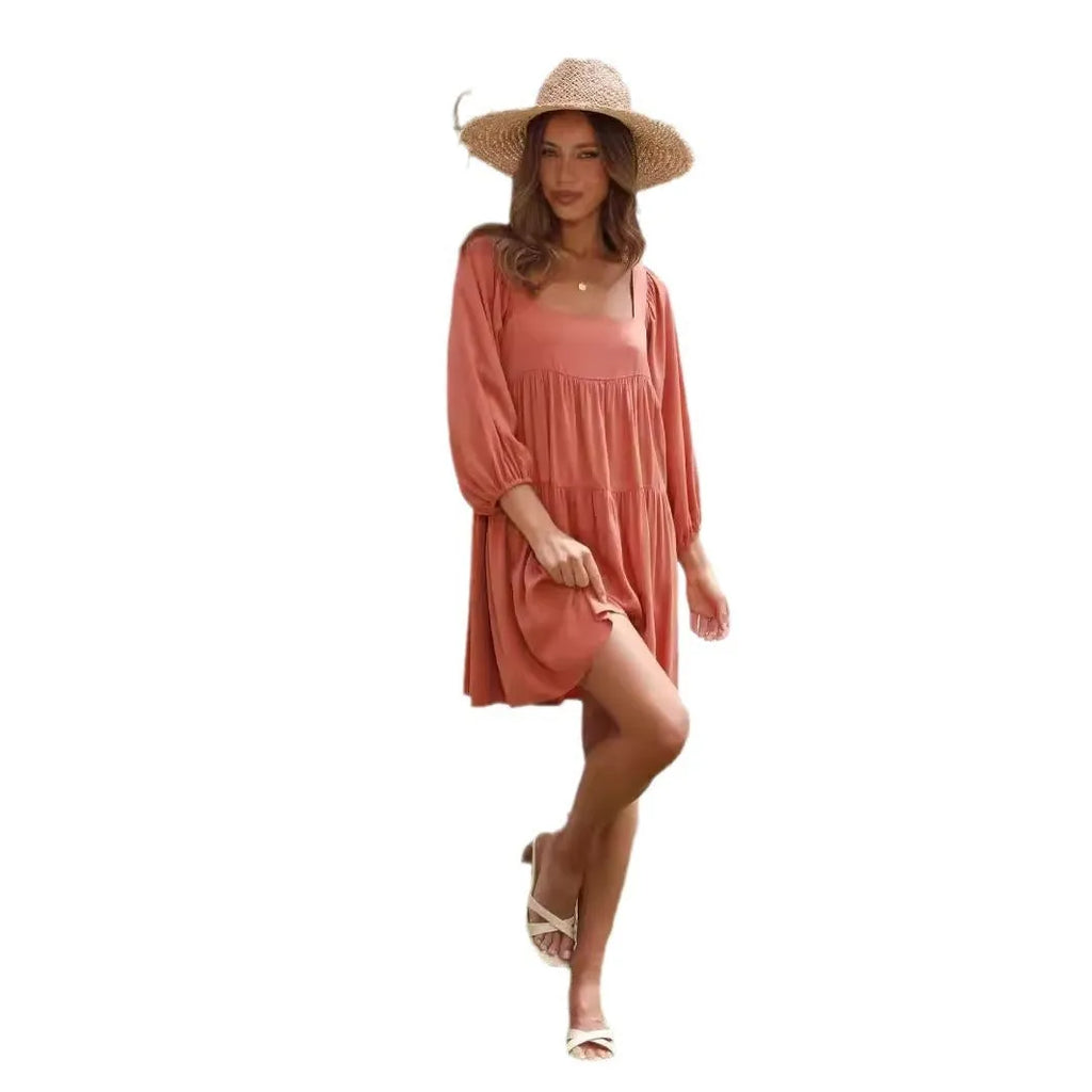 Orange red children's backless pullover dress with puff sleeves and a square collar on a mannequin.