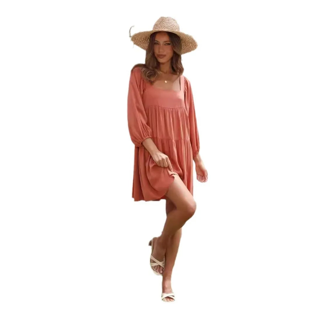 Orange red children's backless pullover dress with puff sleeves and a square collar on a mannequin.