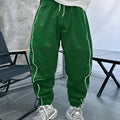 Men's loose-fit casual trousers in bamboo fibre, shown in emerald green colour with cropped leg and elasticated waist.