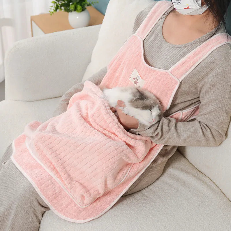 Cloth cat petting apron in a striped pattern, shown worn by a person holding a cat.