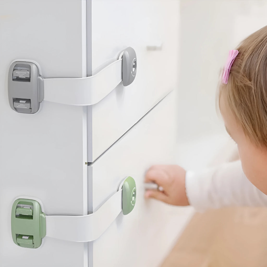 Grey and green adjustable strap child safety lock for cabinets and drawers with adhesive backing