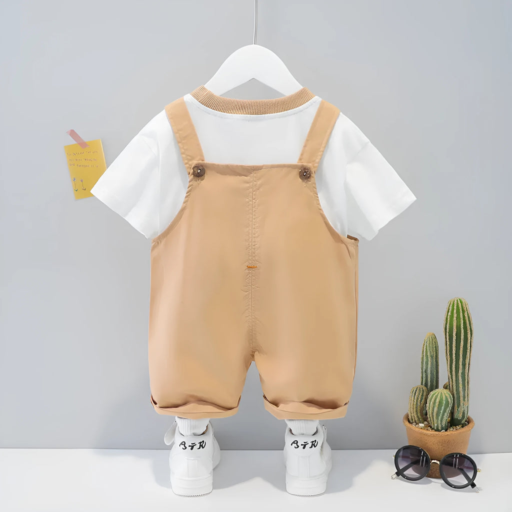Yellow children's cotton short-sleeved romper with cartoon print and adjustable straps.