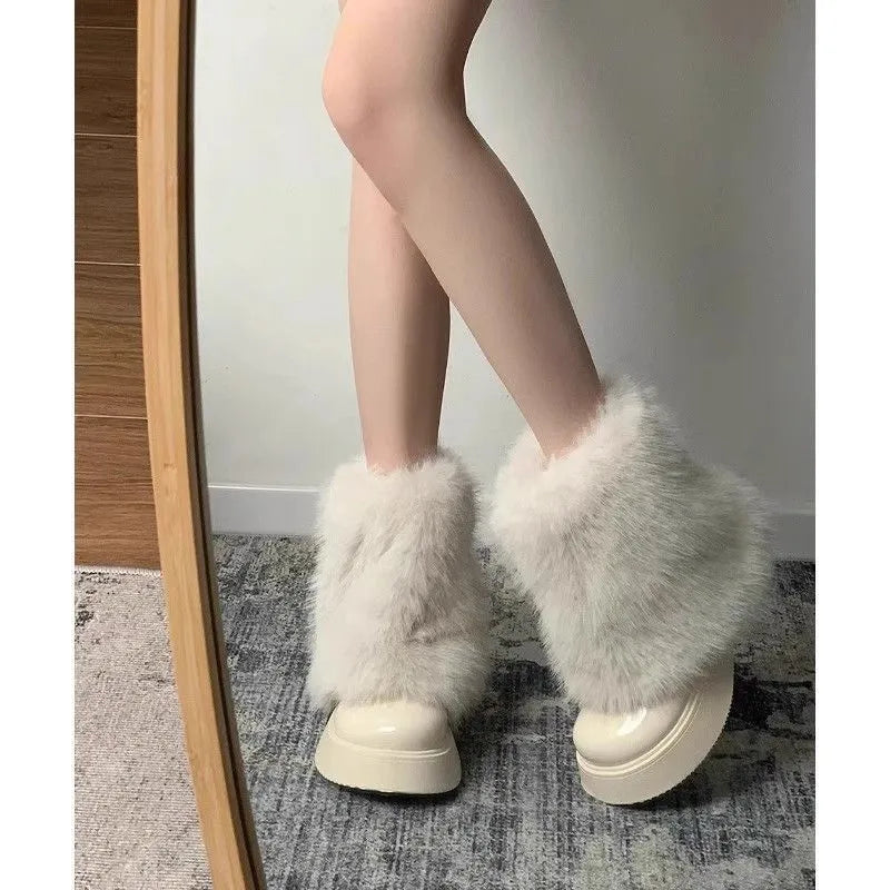 Black low-top snow boot with plush material and a waterproof rubber platform sole.