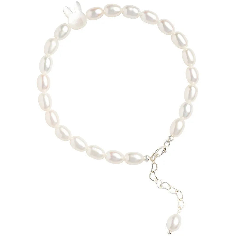 White pearl and 925 silver rabbit charm bracelet on a 16cm elastic string.