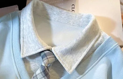 Women's fake two-piece sleeveless sweater top with tie polo collar and plush fabric, blue or gray, cropped length.