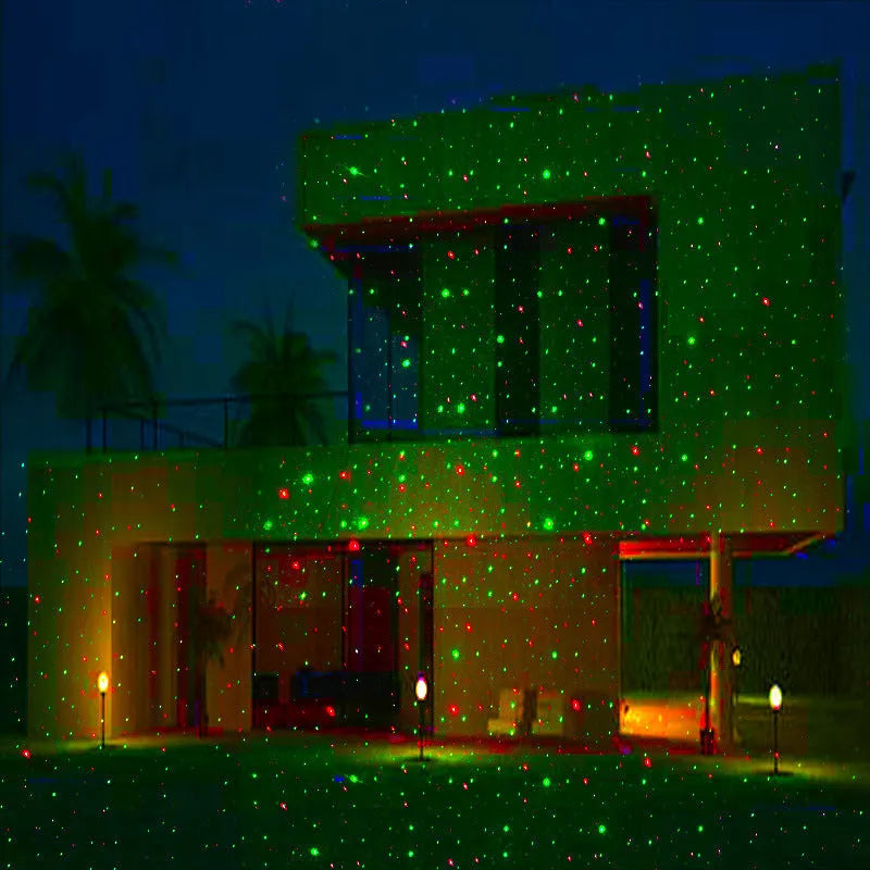 Christmas laser projector projecting red and green laser firefly patterns onto a garden tree at night, IP65 outdoor use