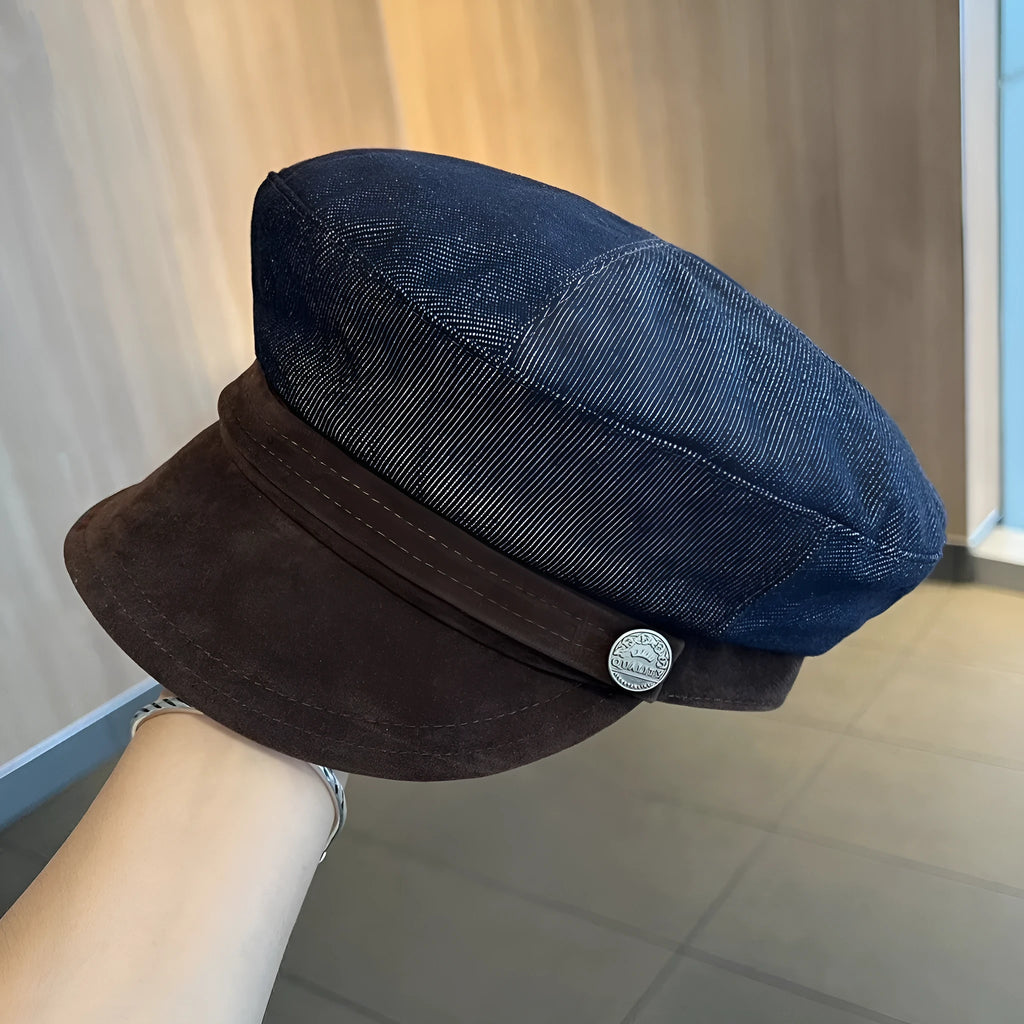 Dark blue denim octagonal newsboy flat cap with an adjustable strap, shown with a contrasting brown brim.