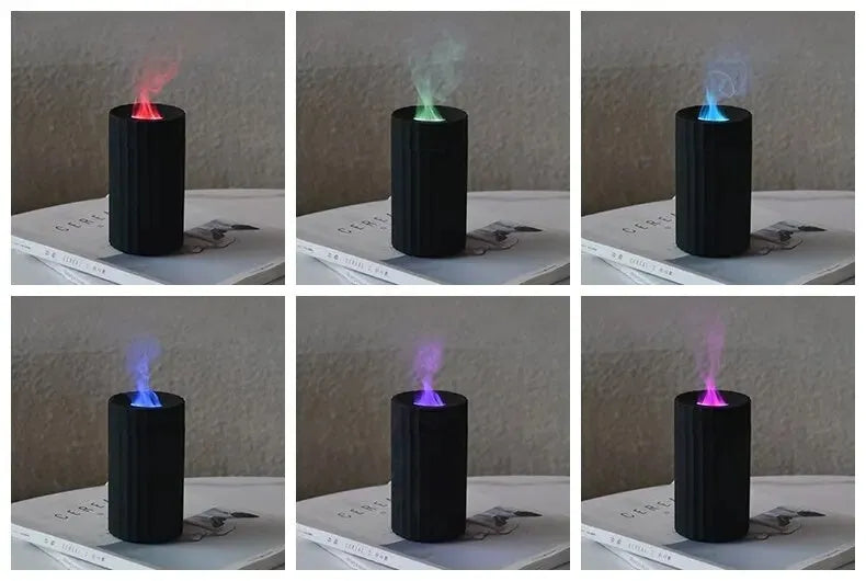 Black portable USB air humidifier and essential oil diffuser with glowing LED flame effect on a table