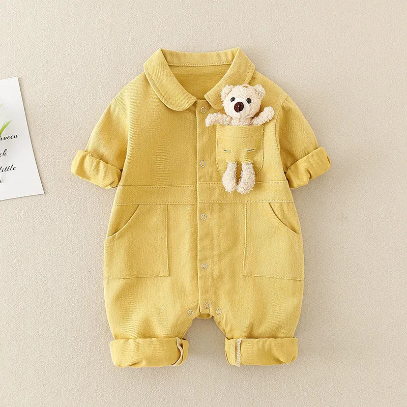 Baby boy wearing blue denim jumpsuit with teddy bear accessory, western style for Spring Festival
