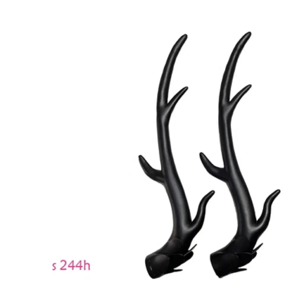 A pair of black resin dragon horn decorations for motorcycle helmet customisation, showing curved shape and mounting base.