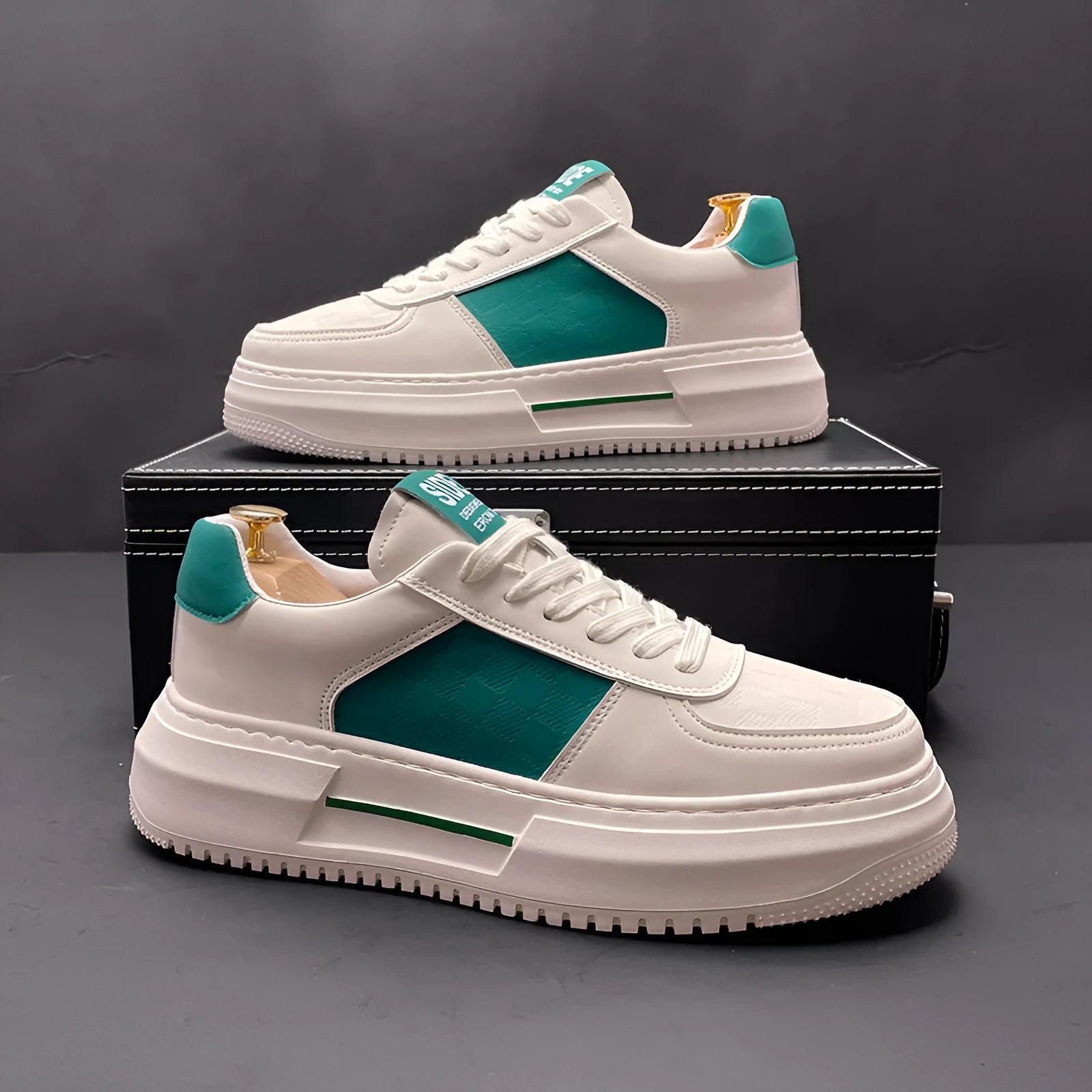 A pair of white, black, and green casual sports shoes with cloth uppers and rubber foam soles.