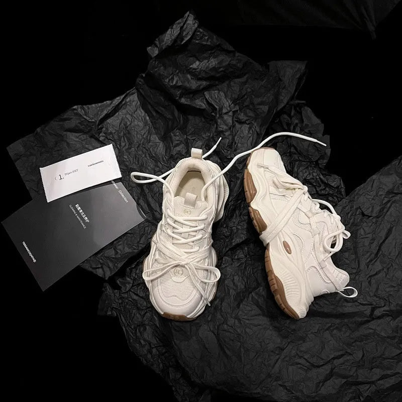 Women's beige platform running sneakers with round toe and lace-up design on white background