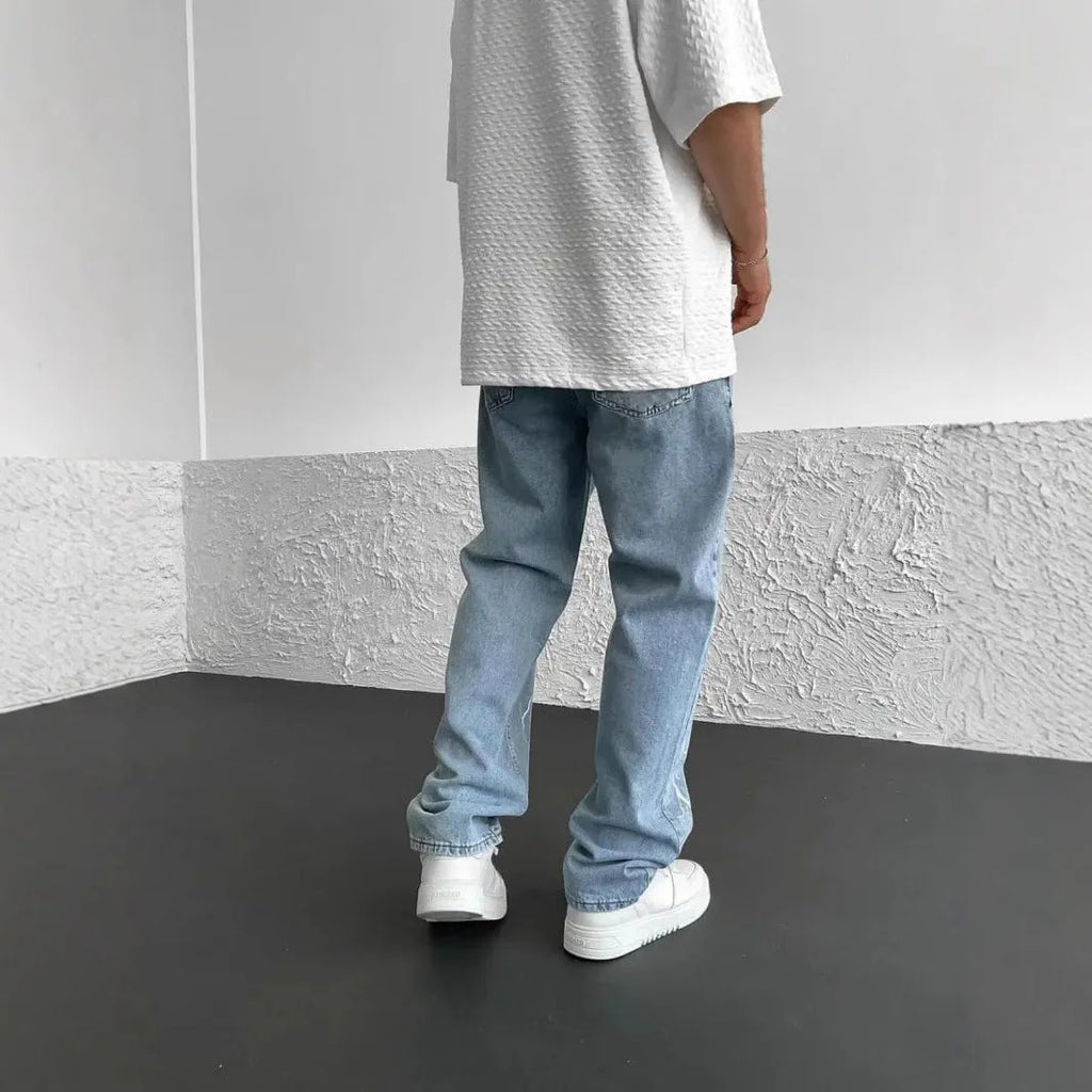 Men's straight-leg denim jeans with mid-waist design showing front view