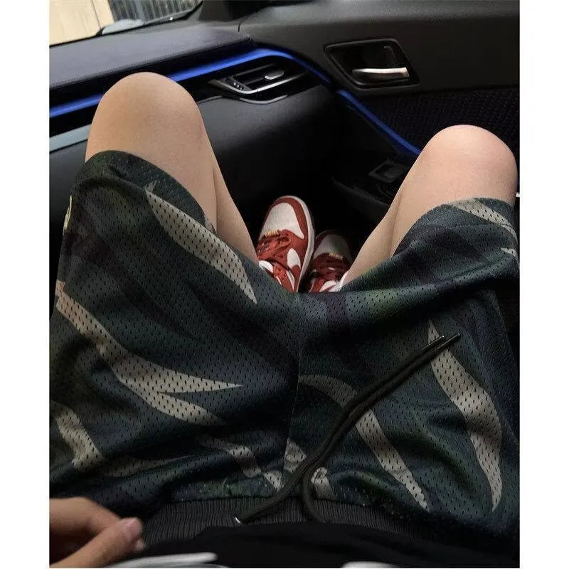 Men's straight-leg camouflage shorts in cotton blend fabric, shown on a size chart.