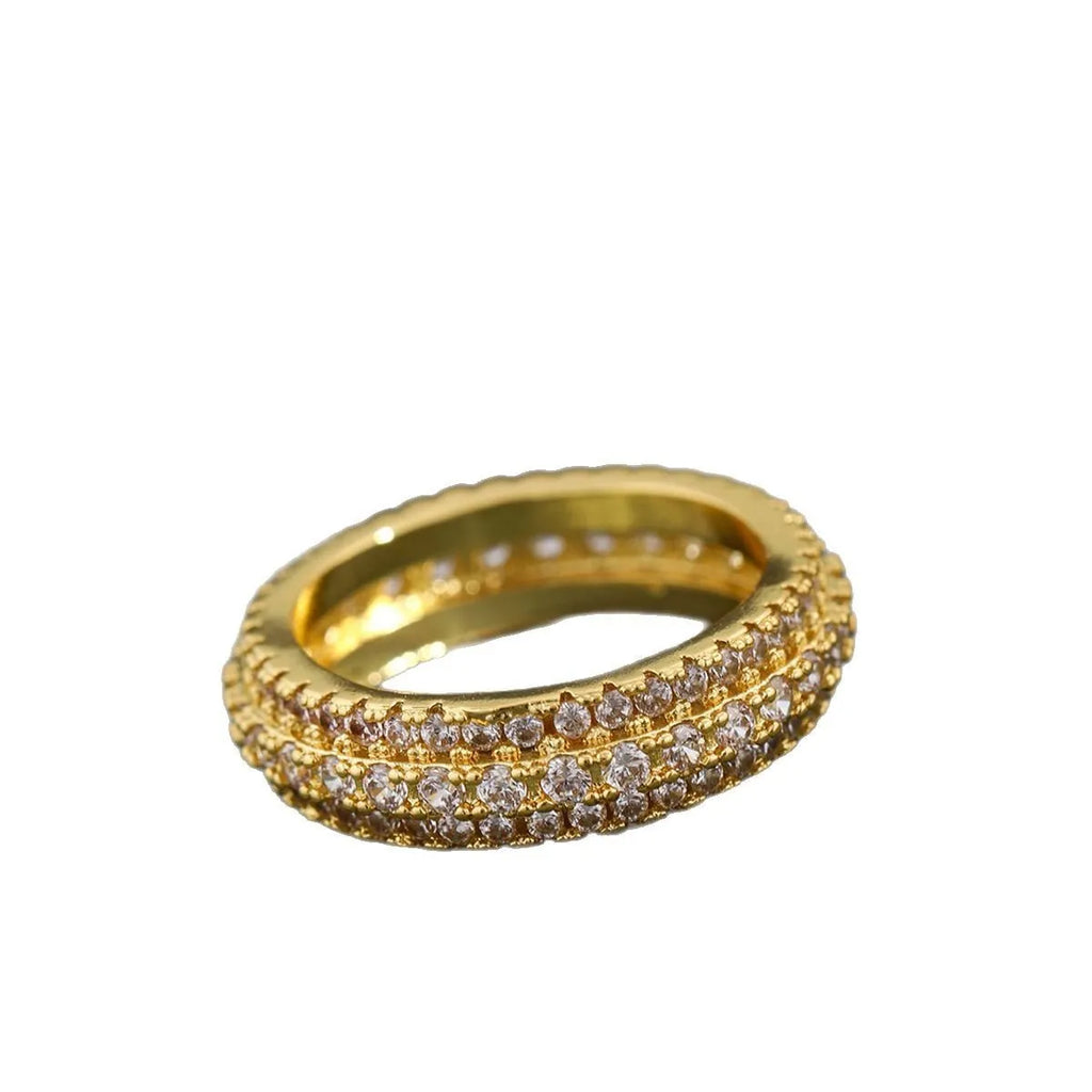 Triangular geometric ring with a zircon stone centre, shown in different metal plating colours.