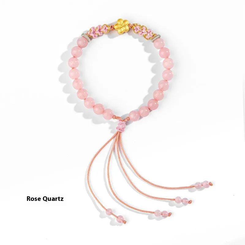 Crystal bracelet with hand-woven red rope strap and peach blossom design in diamond shape