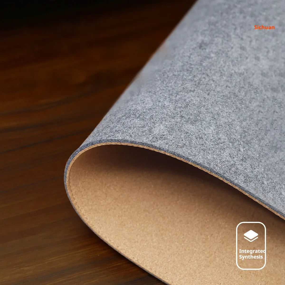 Oversized grey felt and cork office mouse mat on a wooden desk