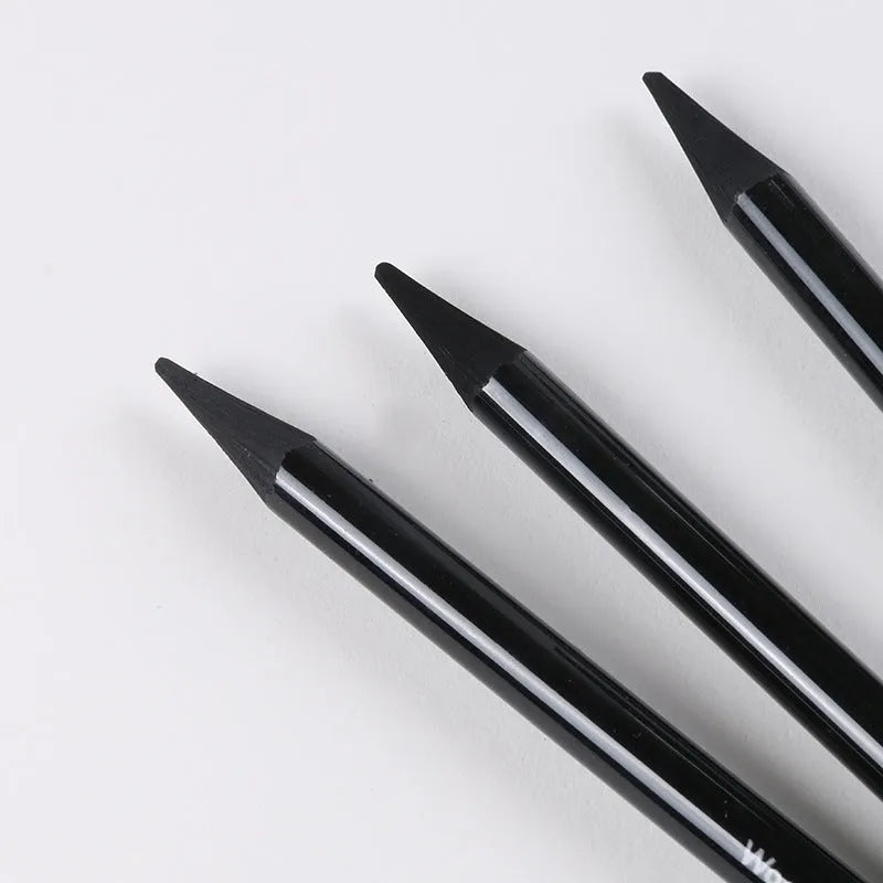 Set of nine drawing pencils with wooden shells, comprising six graphite and three carbonised pencils, on a suction card.
