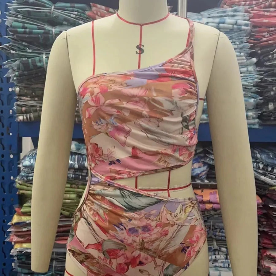 Women's rose gold patterned one-piece swimsuit on hanger