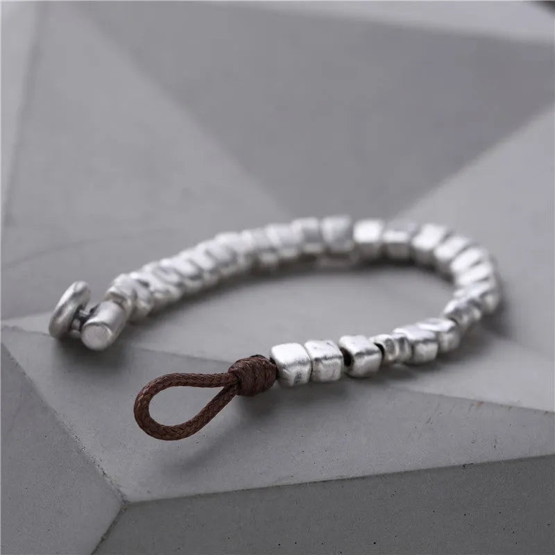 Handmade silver bracelet with irregular square design and wooden elements on 17cm elastic band