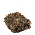 Green camouflage netting cover shown in a desert camouflage pattern, laid over outdoor terrain.