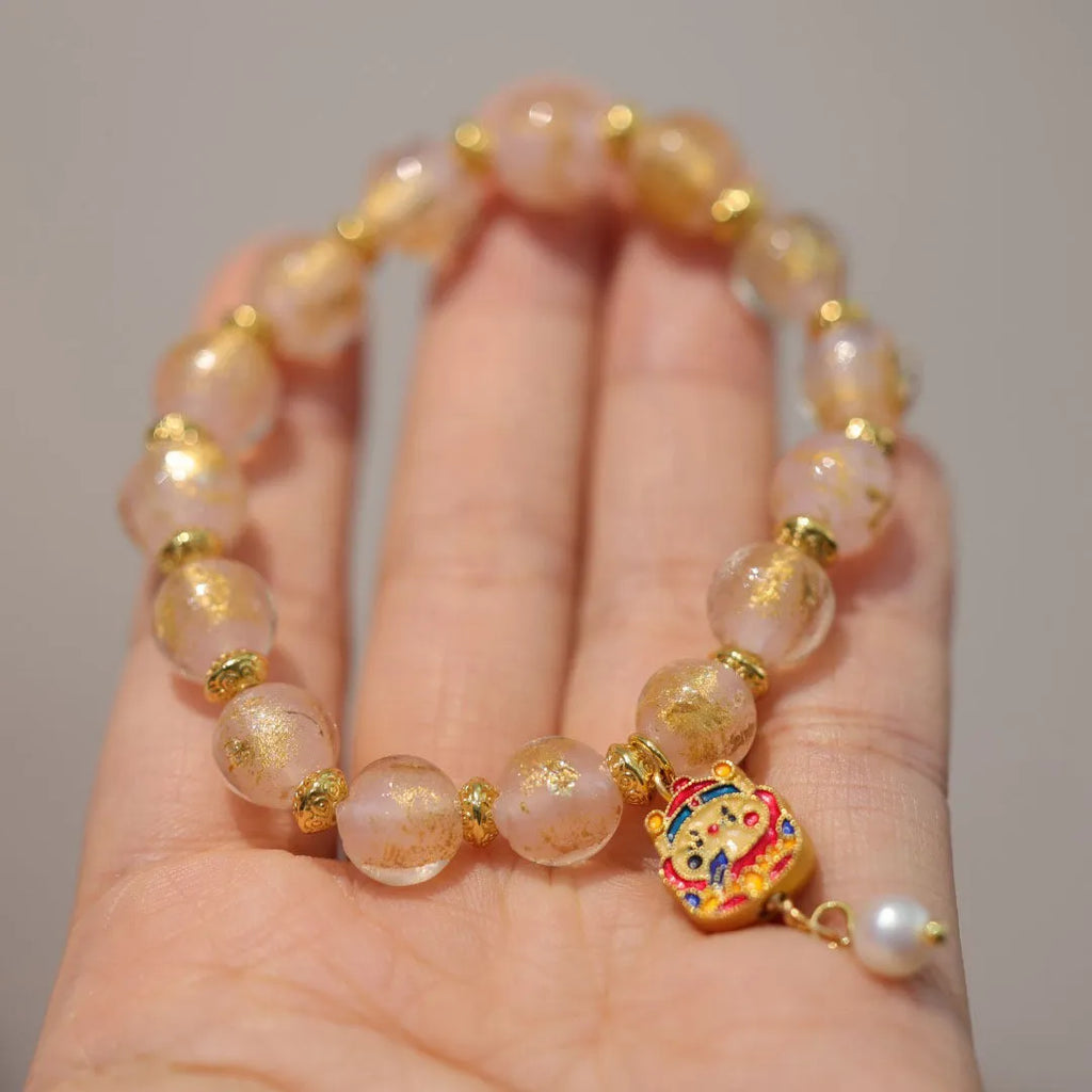Women's ethnic geometric bracelet with gold foil decoration on glass and coloured glaze in two colour options.