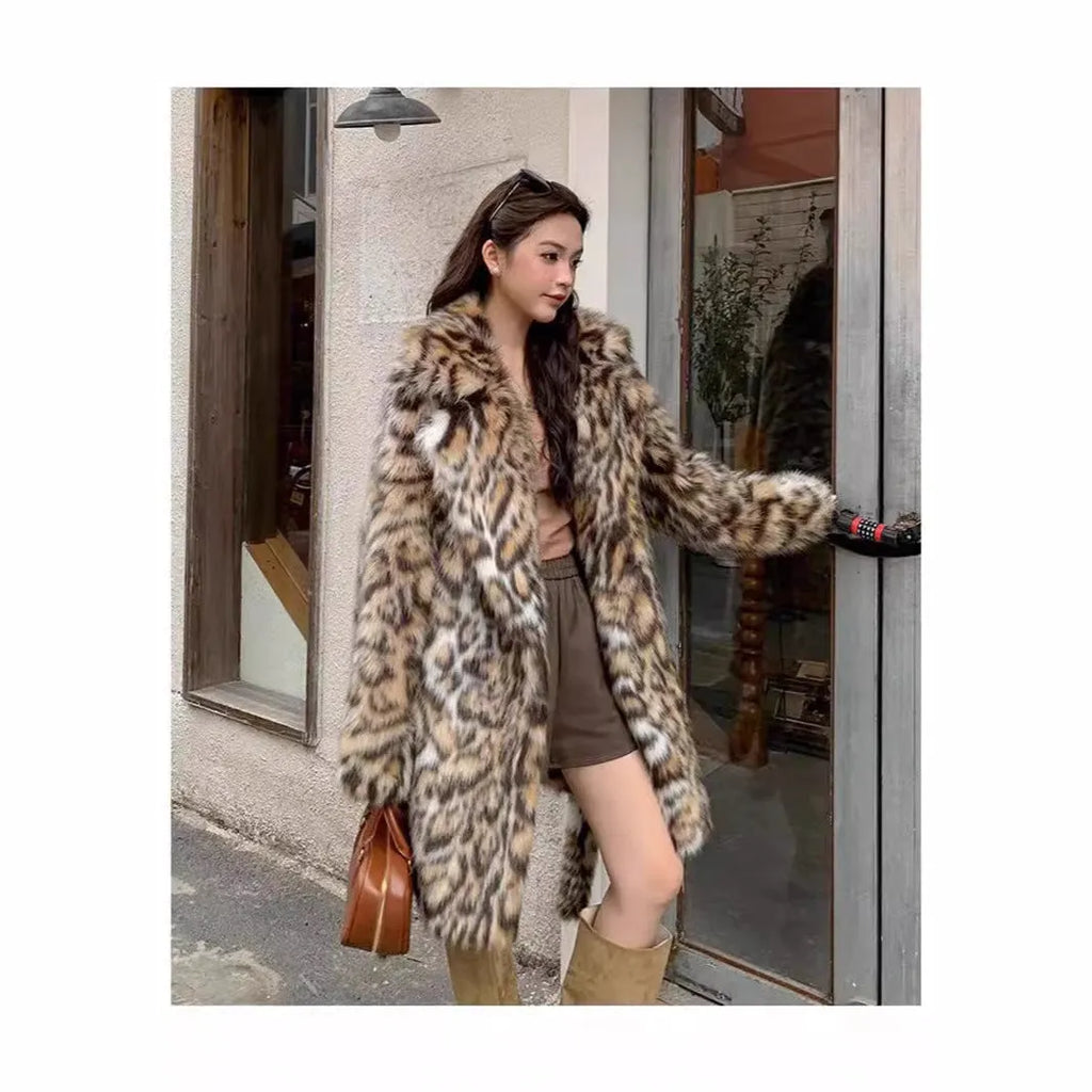 Long grey faux fur coat with a detachable fur collar and pockets on a model.