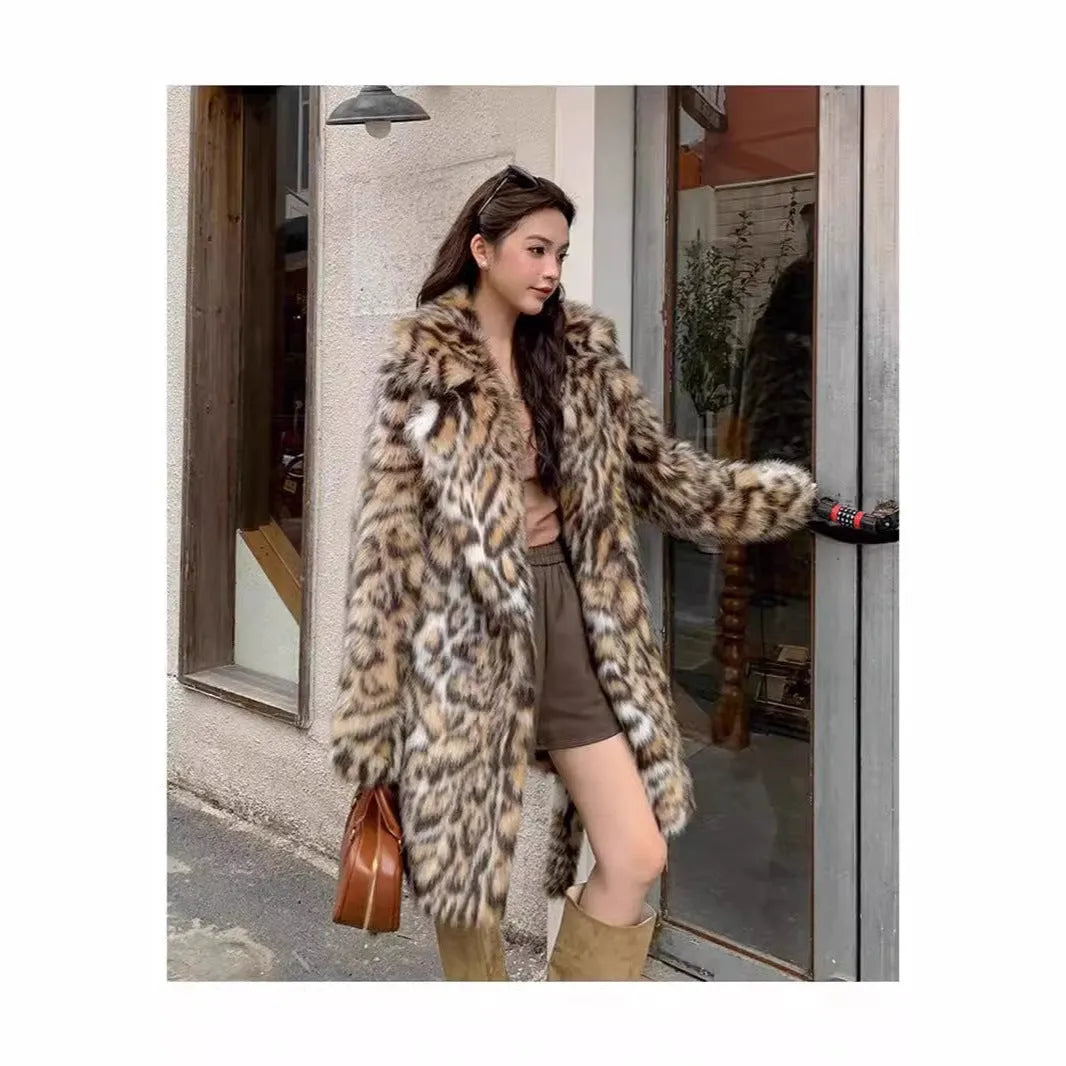 Long grey faux fur coat with a detachable fur collar and pockets on a model.
