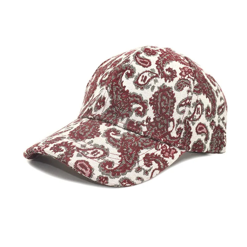Paisley pattern printed baseball cap in blue with dome crown style on a white background.