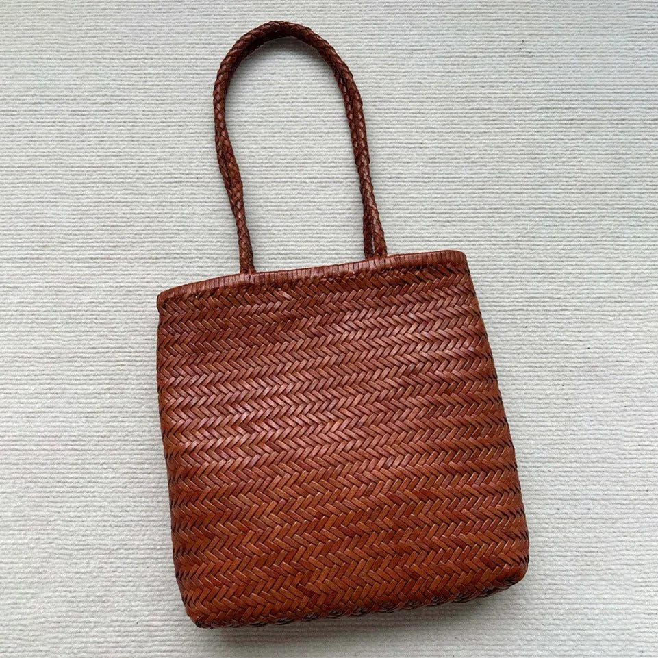 Brown handmade woven cowhide leather tote bag with a three-dimensional outer pocket.