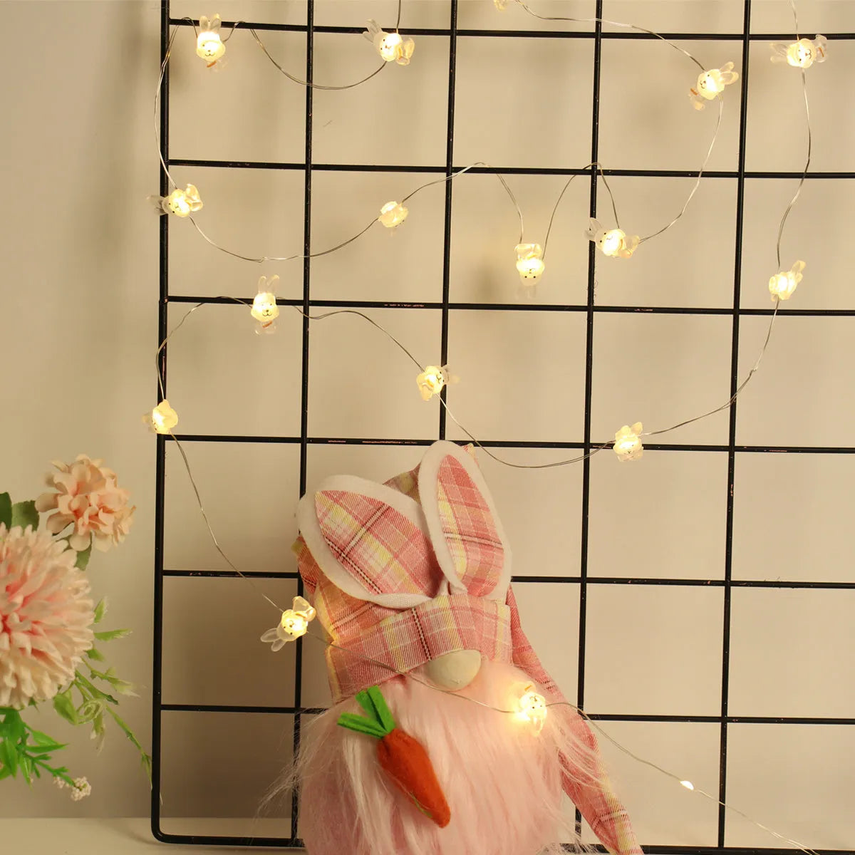 Easter LED bunny string lights with carrot and white rabbit bulbs on a dark background