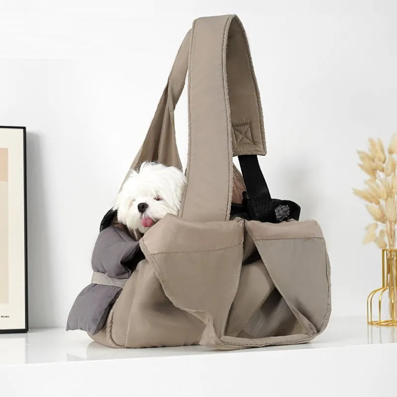 Apricot-colour cloth pet carrier handbag with mesh panels and a shoulder strap.