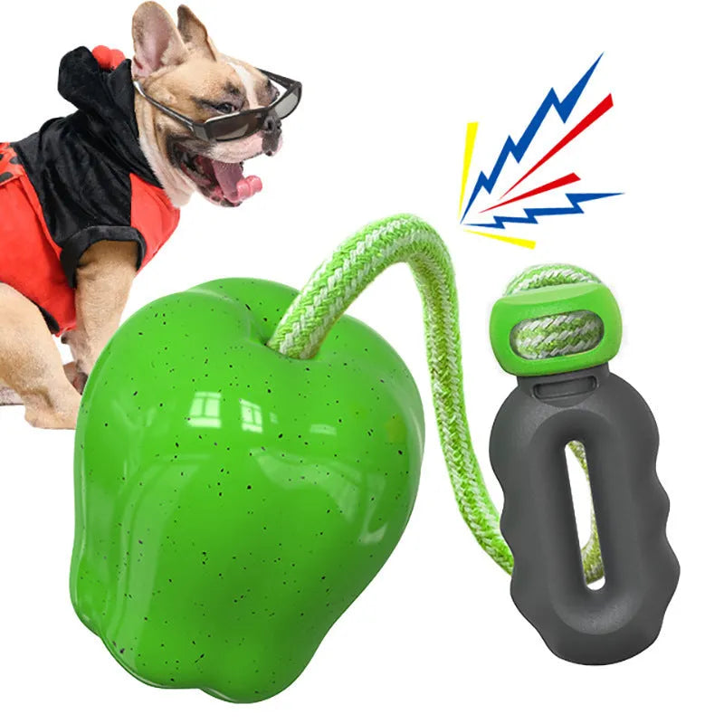 Green plastic squeaky apple dog toy for molar cleaning and outdoor fetch.