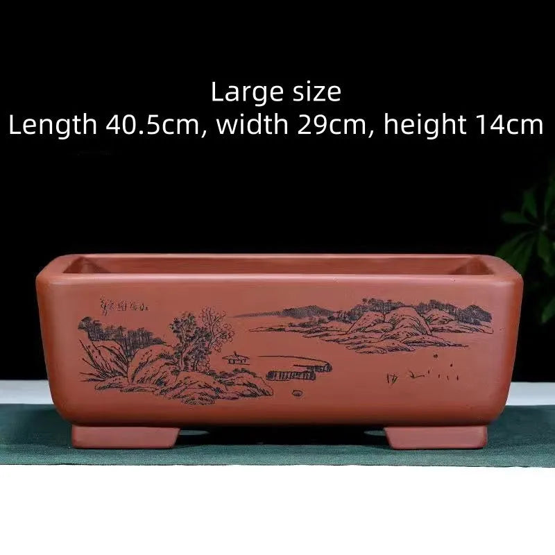 Handmade deep blue black rectangle purple clay bonsai pot on a wooden surface.