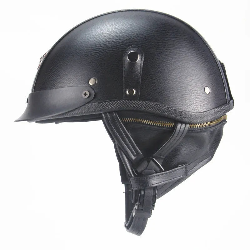 Retro black leather motorcycle helmet with a half-visor on a background.