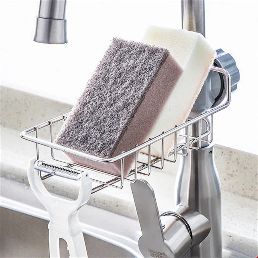 Adjustable stainless steel sink drain rack clipped onto a kitchen faucet with sponge and soap stored on the removable holder
