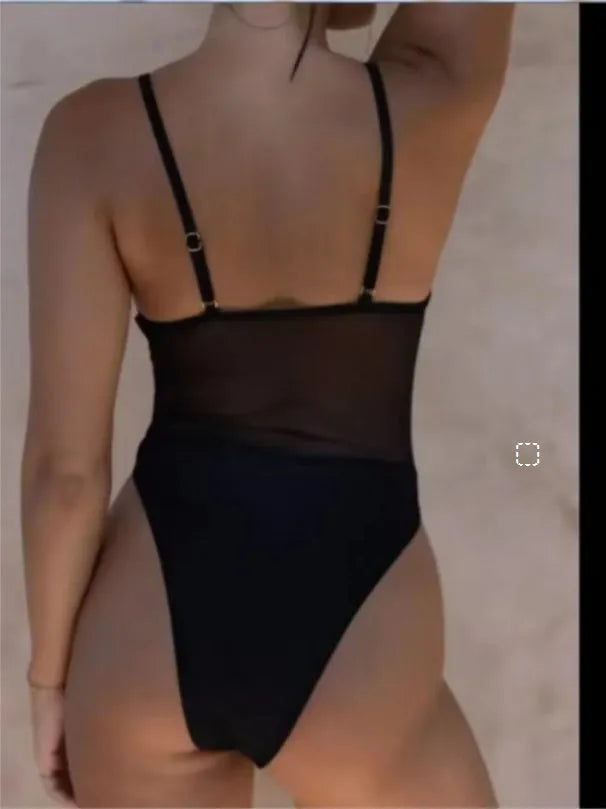 Black transparent banded bikini style one-piece swimsuit for women on mannequin
